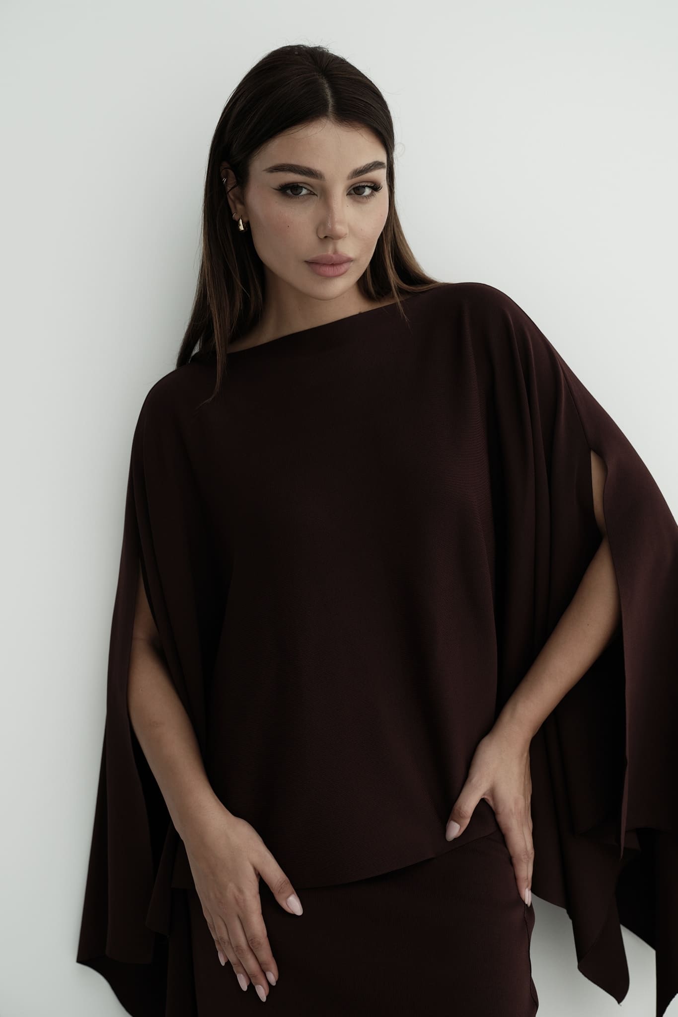 Model wearing Amanda Set featuring a draped cape top and a matching floor-length skirt, styled with white strappy sandals, standing against a white background